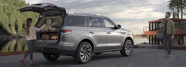 a silver suv with open trunk